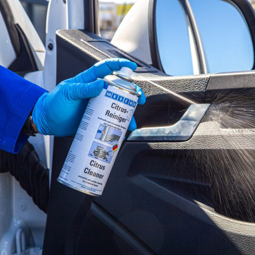 Citrus Cleaner disinfecting a car door handle